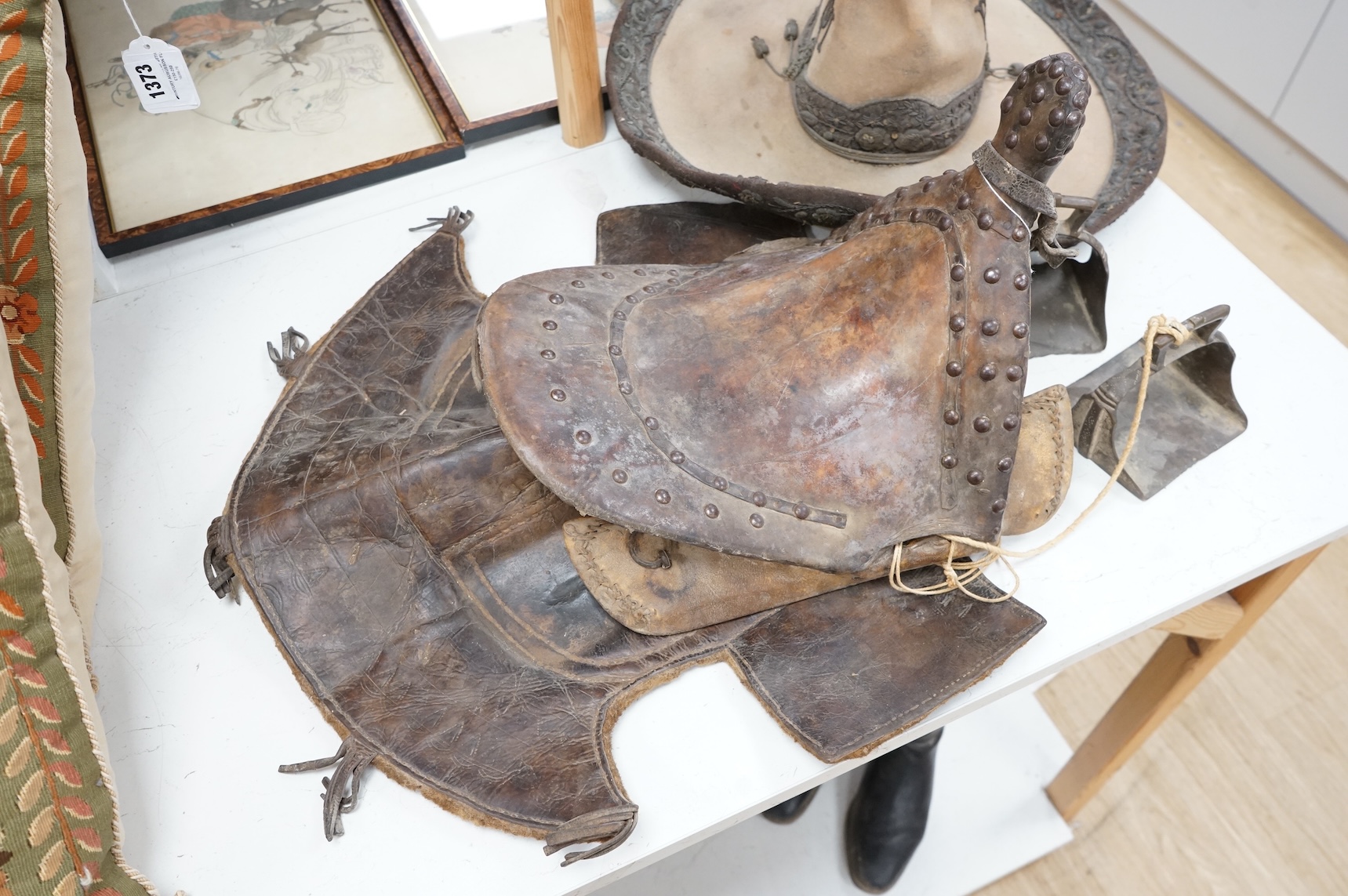 A Spanish Colonial leather saddle and a Spanish Colonial bullion work sombrero, saddle 59cm long